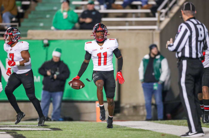 Nov 27, 2021; Huntington, West Virginia, USA; Western Kentucky Hilltoppers wide receiver Malachi Corley (11) catches a pass for a touchdown and celebrates with teammates during the third quarter against the Marshall Thundering Herd at Joan C. Edwards Stadium. Mandatory Credit: Ben Queen-USA TODAY Sports